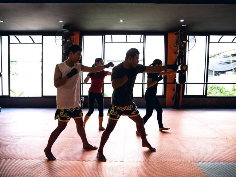 A group of students trains martial arts in a martial arts studio.