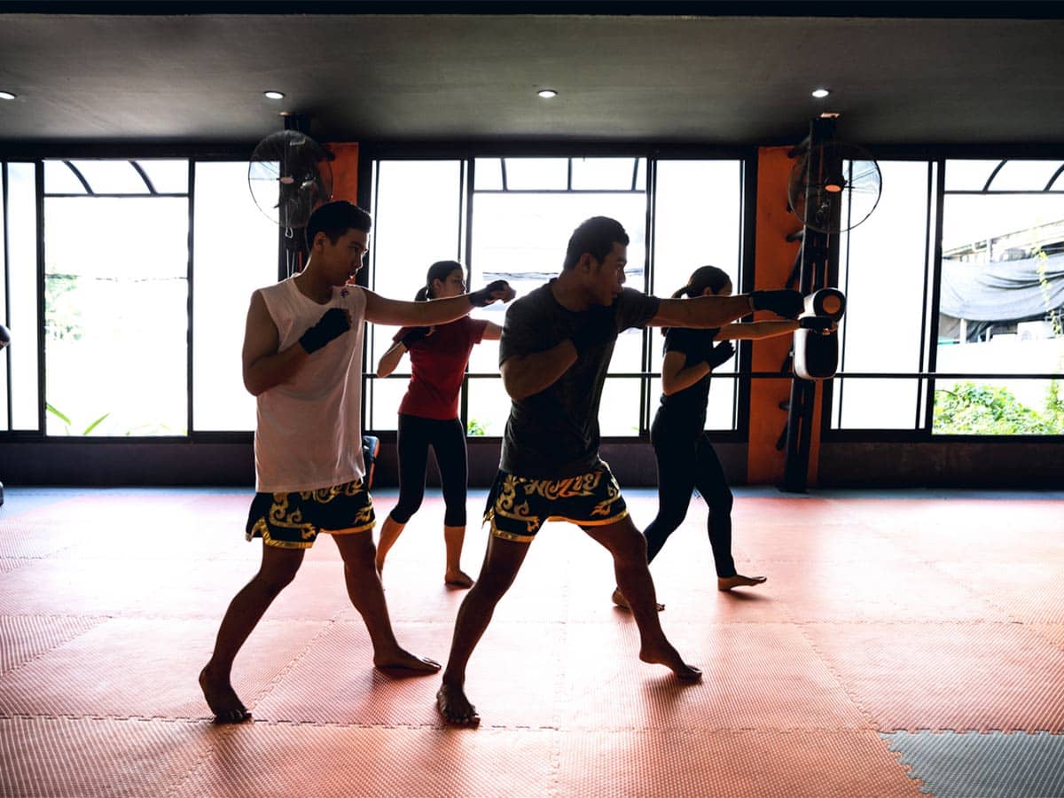 A group of students trains martial arts in a martial arts studio.